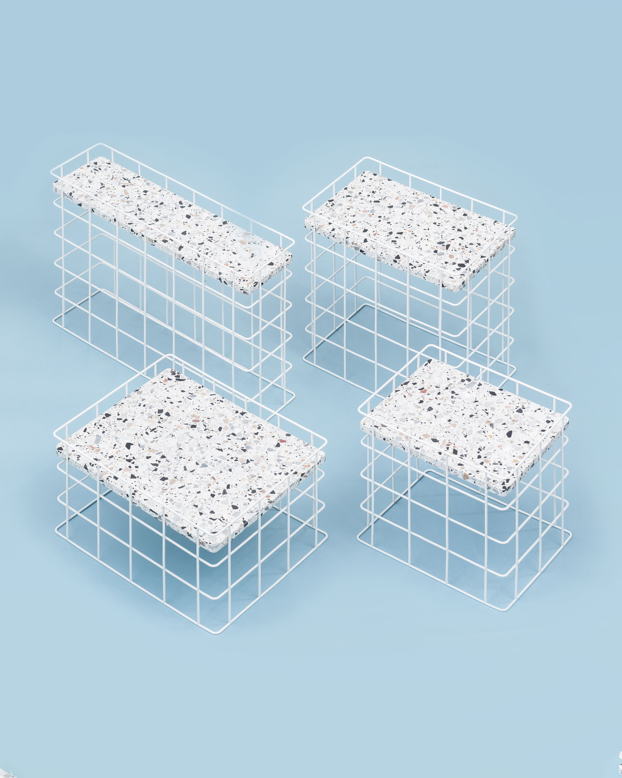 Four side tables consisting of a wire grid base and a terrazzo tabletop.