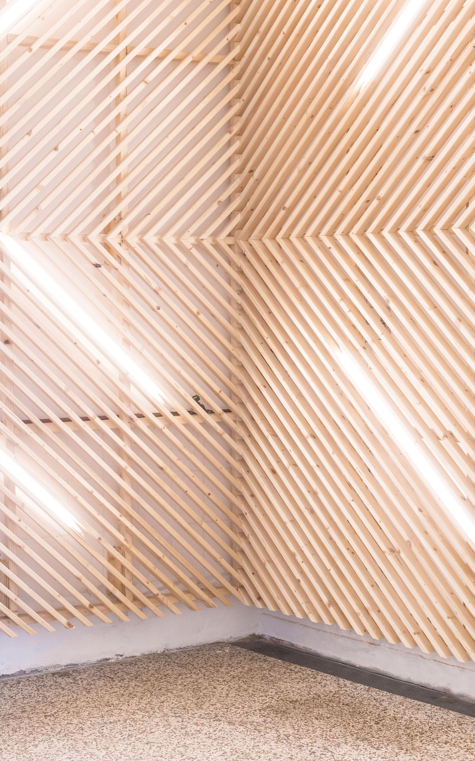 Decorative wooden elements with neon lights in between them.