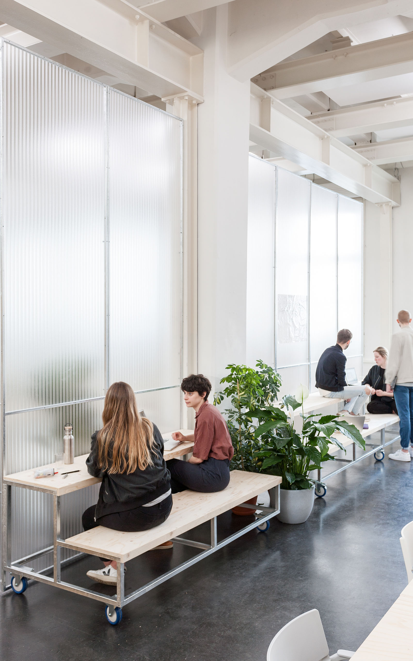 people sitting on benches of mobile elements and talk to each other.