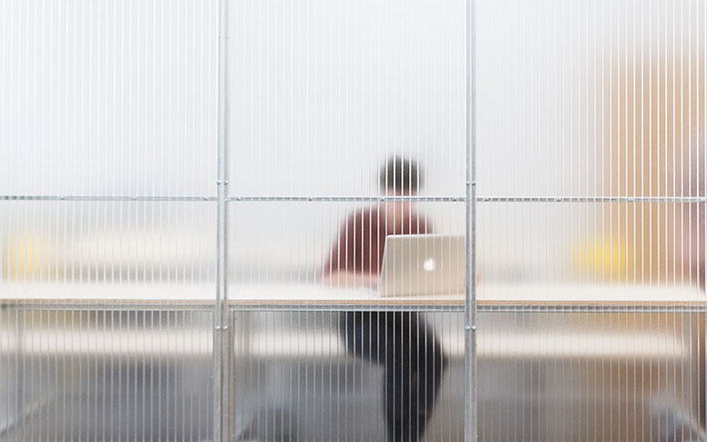 A silhouette of a person seen through translucent material.